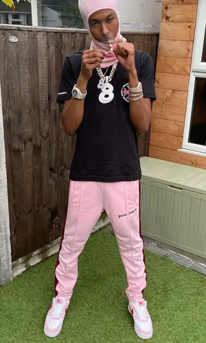 DigDat wearing Palm Angels pants