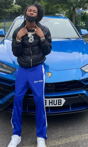 DigDat wearing Palm Angels pants