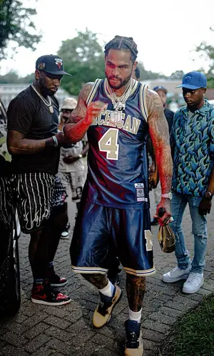 Dave East wearing Mitchell & Ness shorts