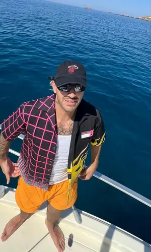 Feid wearing Bottega Veneta shorts