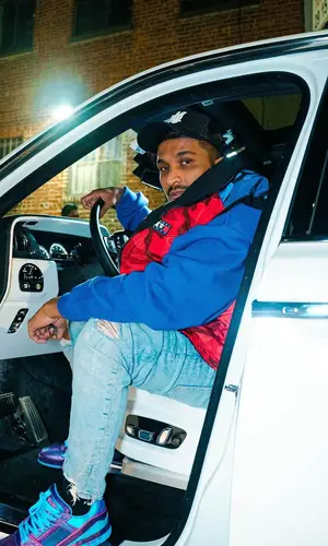Divine wearing Tommy Hilfiger jacket