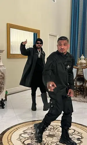 Divine wearing Prada pants