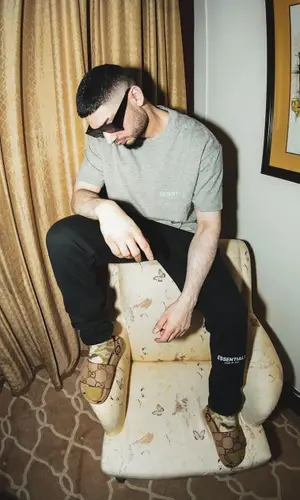 KR$NA wearing Fear of God t-shirt