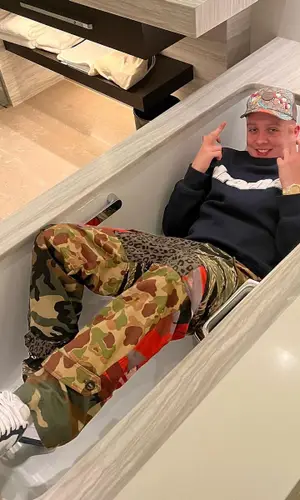 Aitch wearing Palm Angels pants