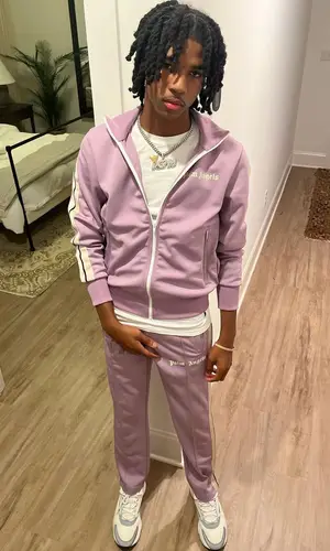 Lil Darius wearing Palm Angels pants