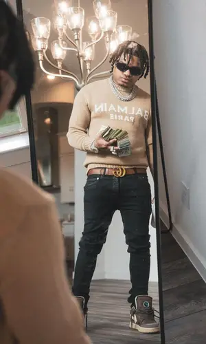 No Cap’s Outfit in Balmain Sweater, Gucci Belt & Prada Eyewear (2022)