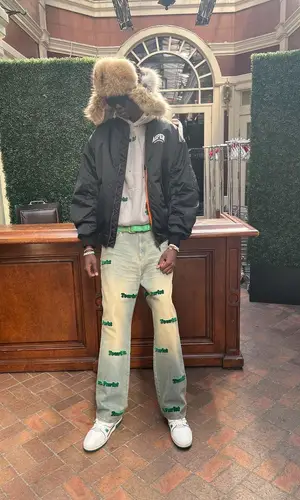 Bol Bol wearing Aris Tatalovich belt