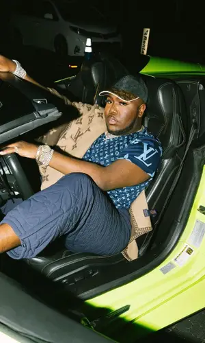 Saucy Santana wearing Louis Vuitton cap