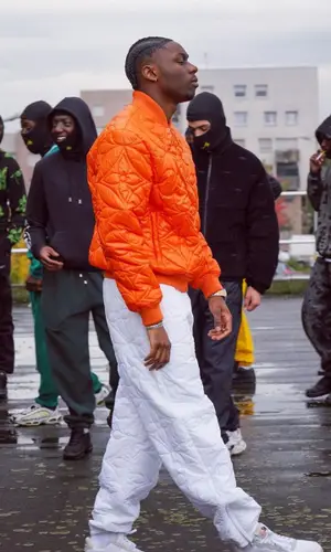 Tiakola wearing Louis Vuitton pants