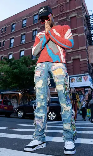 Swoosh God wearing Who Decides War jeans