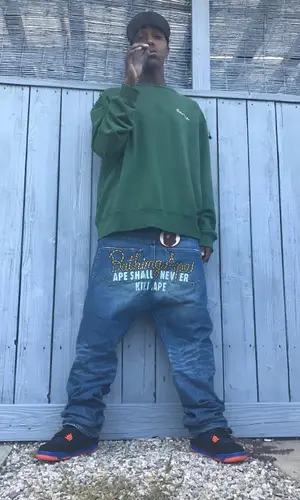 Swoosh God wearing Champion sweatshirt