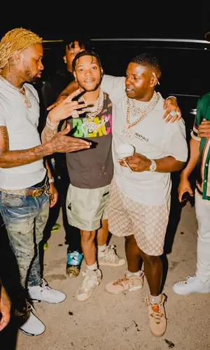Lil Migo wearing Fear of God shorts