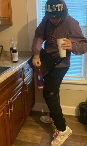 YP4AM wearing Stone Island pants