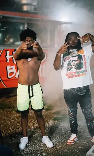Tee Grizzley wearing Amiri jeans