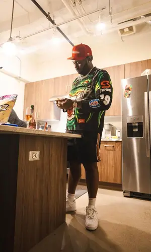 Peezy wearing Supreme jersey