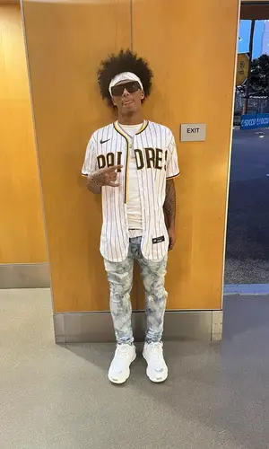 Mikey wearing Purple Brand jeans