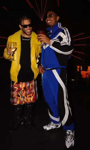 Myke Towers wearing Louis Vuitton trousers