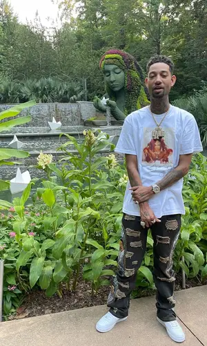 PnB Rock’s Outfit in Supreme T-Shirt, Barriers Jeans & Who Decides War (2022)