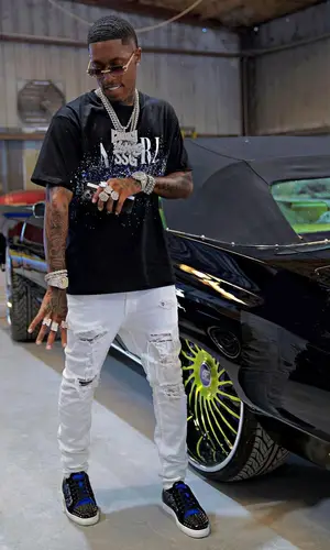 CoreySSG wearing Amiri jeans