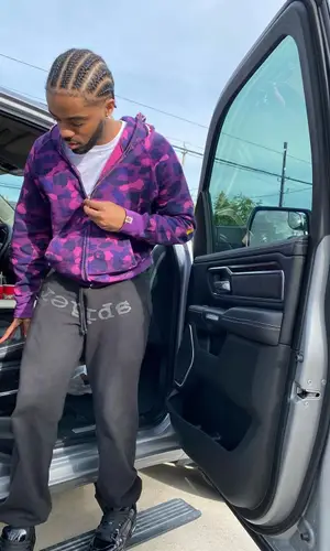 Lil Playah wearing Louis Vuitton sneakers