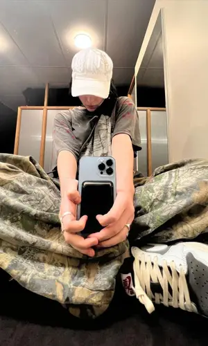 Billie Eilish’s Outfit in Nike Sneakers, StoreRoomVintage Cap & Travis Scott Merch (2022)