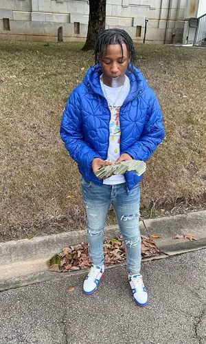 Lil Kee wearing Louis Vuitton jacket