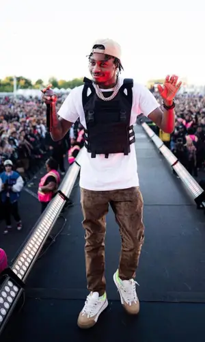 Lil Tjay wearing Cactus Jack sweater