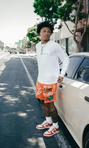 Mikey wearing Confidential shorts