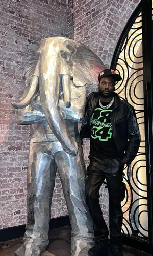 Meek Mill wearing Louis Vuitton jacket