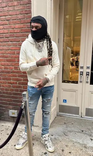 Lil Dude wearing Amiri jeans