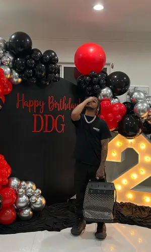DDG wearing Goyard bag