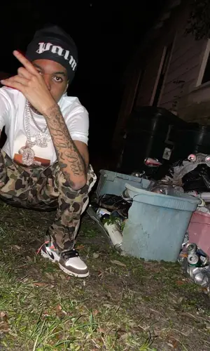 Lil Poppa wearing Palm Angels pants