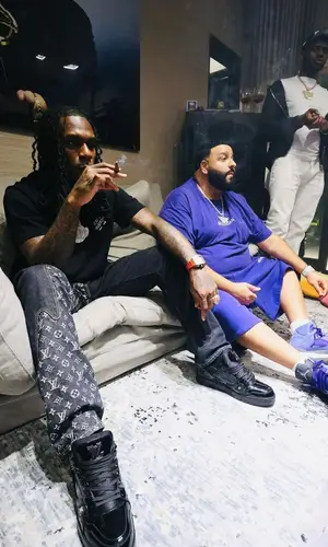 Burna Boy wearing Louis Vuitton shirt