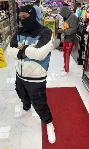 Peezy wearing Kith pants