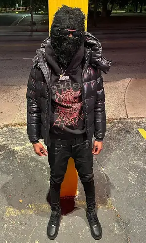Lil Darius wearing Greedy Unit hat