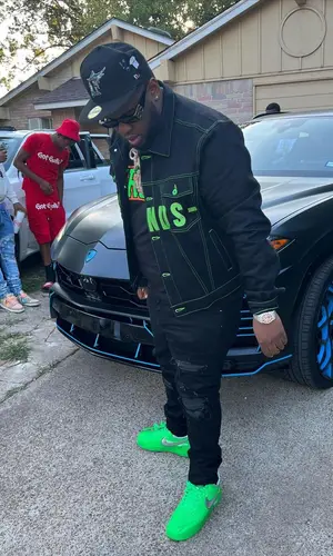 Maxo Kream’s Outfit in Vlone Jacket, Balenciaga Eyewear & New Era Cap (2022)