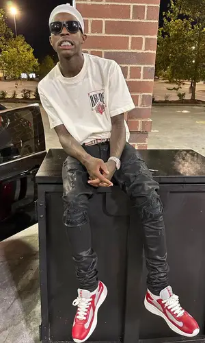 Quando Rondo wearing Burberry belt