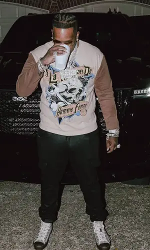 Finesse2tymes wearing Amiri pants