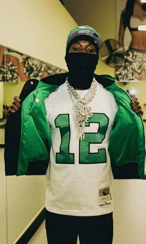 Meek Mill wearing Mitchell & Ness jersey