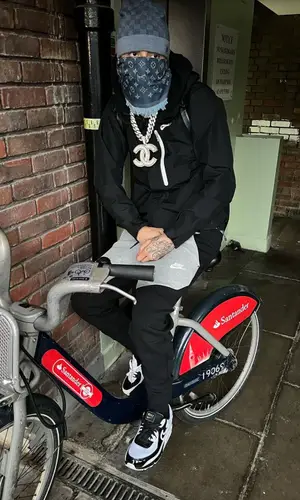 Central Cee wearing Louis Vuitton scarf