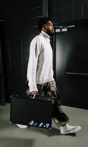 Karl Anthony Towns wearing Louis Vuitton pants