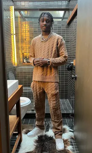 Lil Tjay wearing Laneus sweater