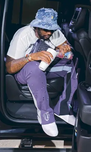 Peezy wearing Gallery Dept. pants