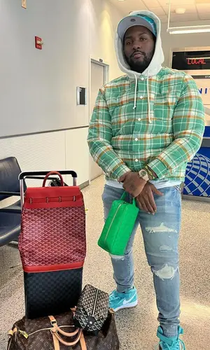 Peezy wearing Goyard backpack