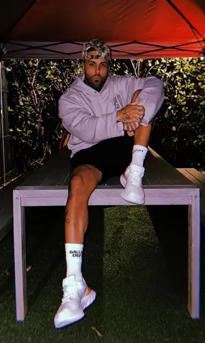 Nicky Jam’s Outfit in Honor The Gift Hoodie, Nike Sneakers & Gallery Dept. Socks (2022)