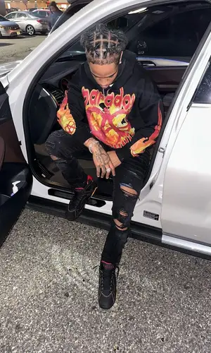 C Blu wearing Amiri jeans