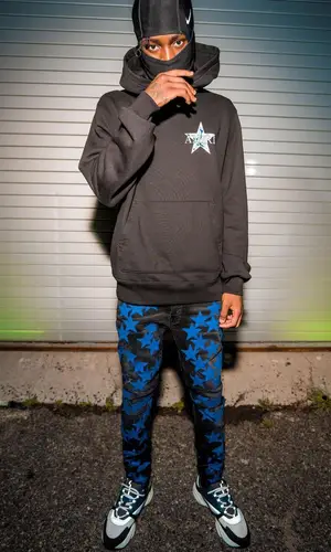 Kyle Richh wearing Amiri jeans