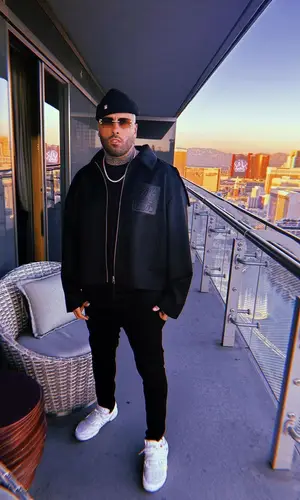 Nicky Jam’s Outfit in Loewe Jacket, Off-White Sneakers & Cartier Eyewear (2022)