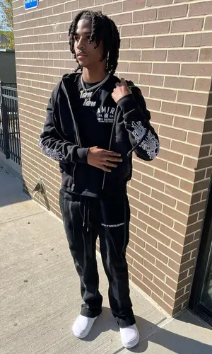 Lil Darius wearing Retrovert pants
