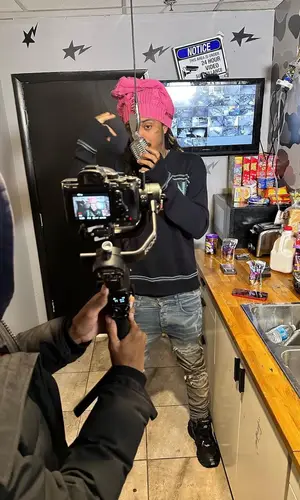 Lil Dude wearing Amiri jeans